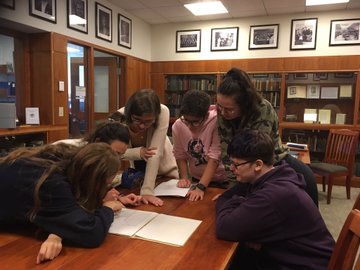 Students studying together in the archives.