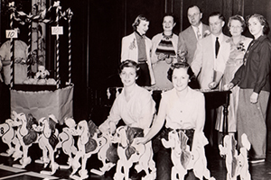 Students and faculty standing with toy poodles