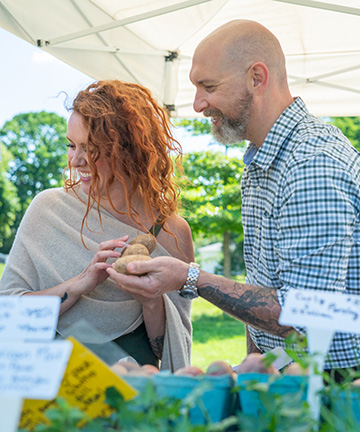 Maggie Knowles with partner Chef Josh Berry at a local farmers' market in Maine.