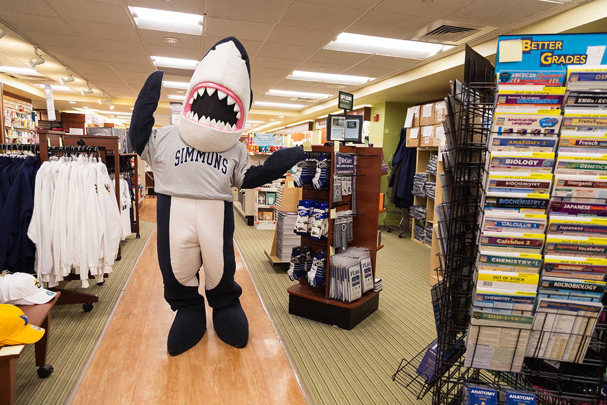 Stormy, the Simmons mascot, wearing a Simmons shirt in the Bookstore