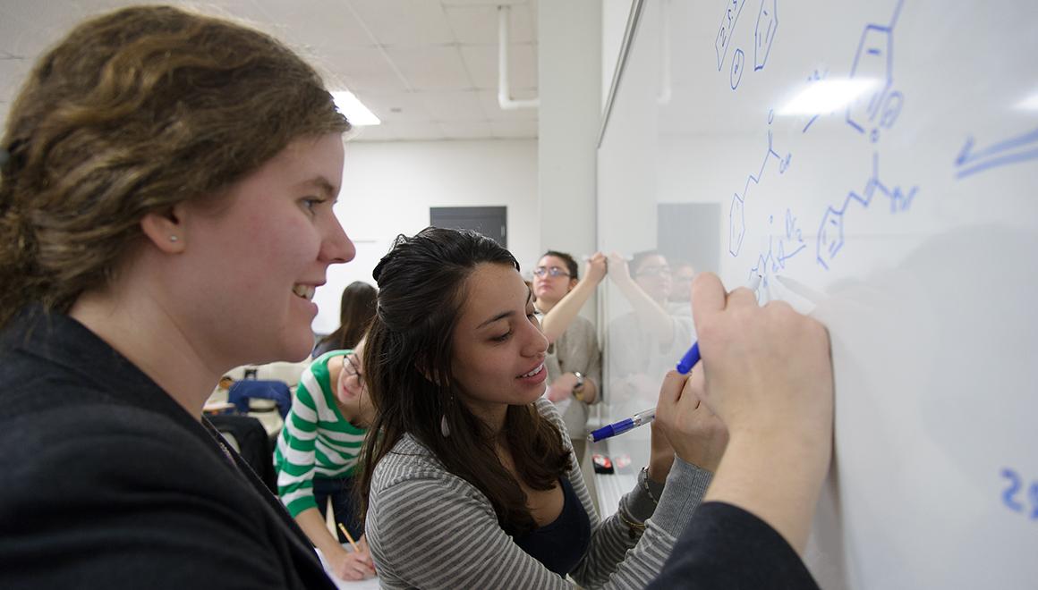 Students working on a white board