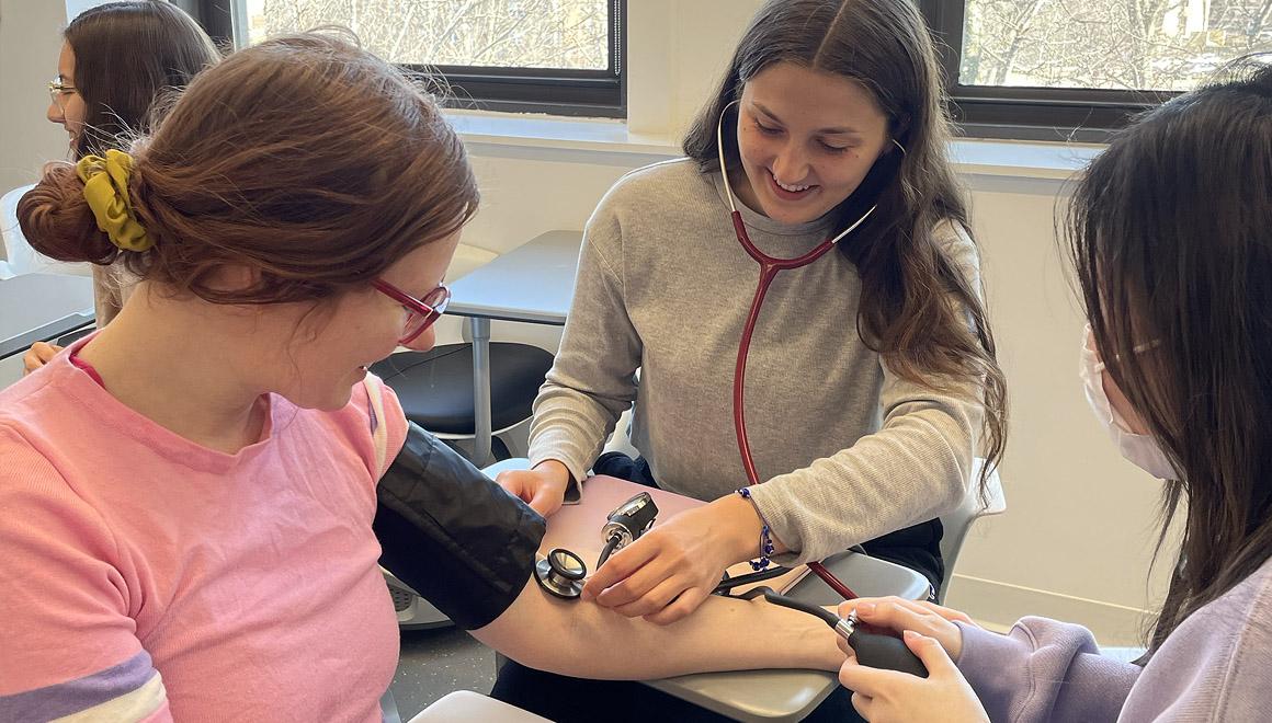 Students practicing taking blood pressure readings
