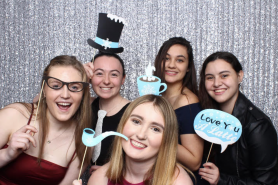 Sarah Mariski in a photo booth with friends during the Simmons Soiree