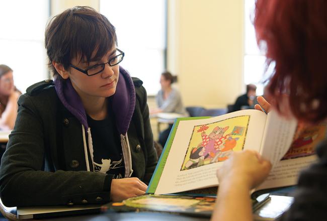 Student looking at a picture book