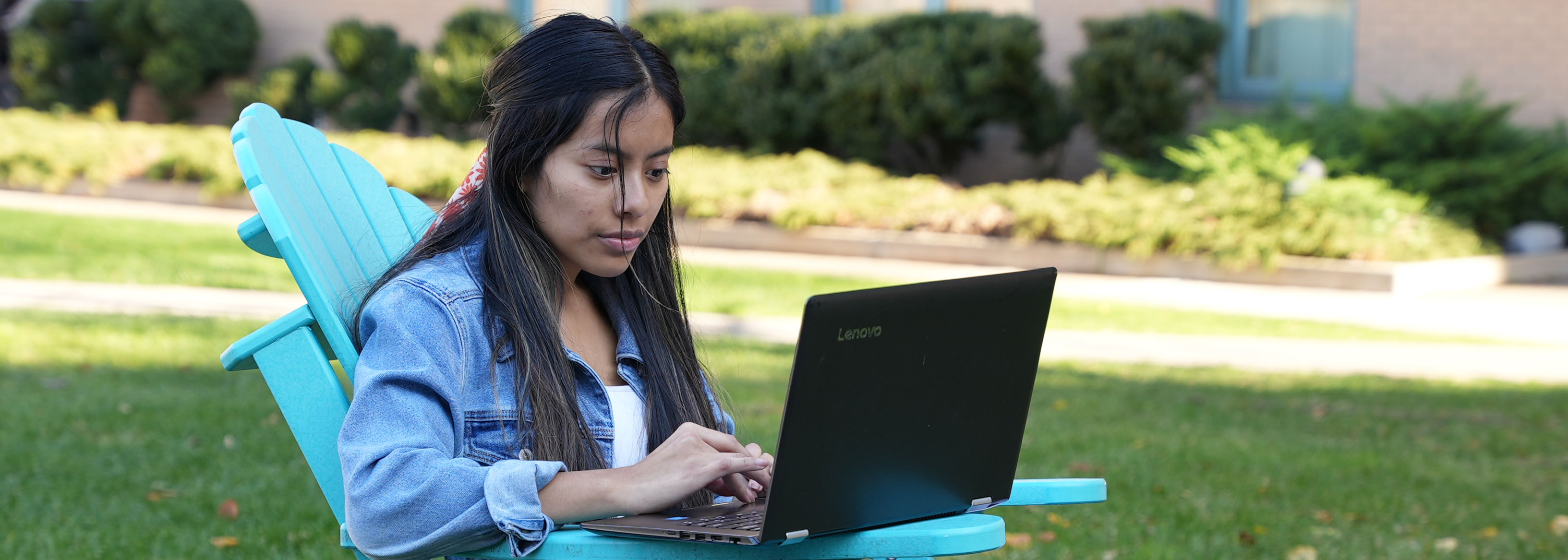 Student studying on a laptop outside