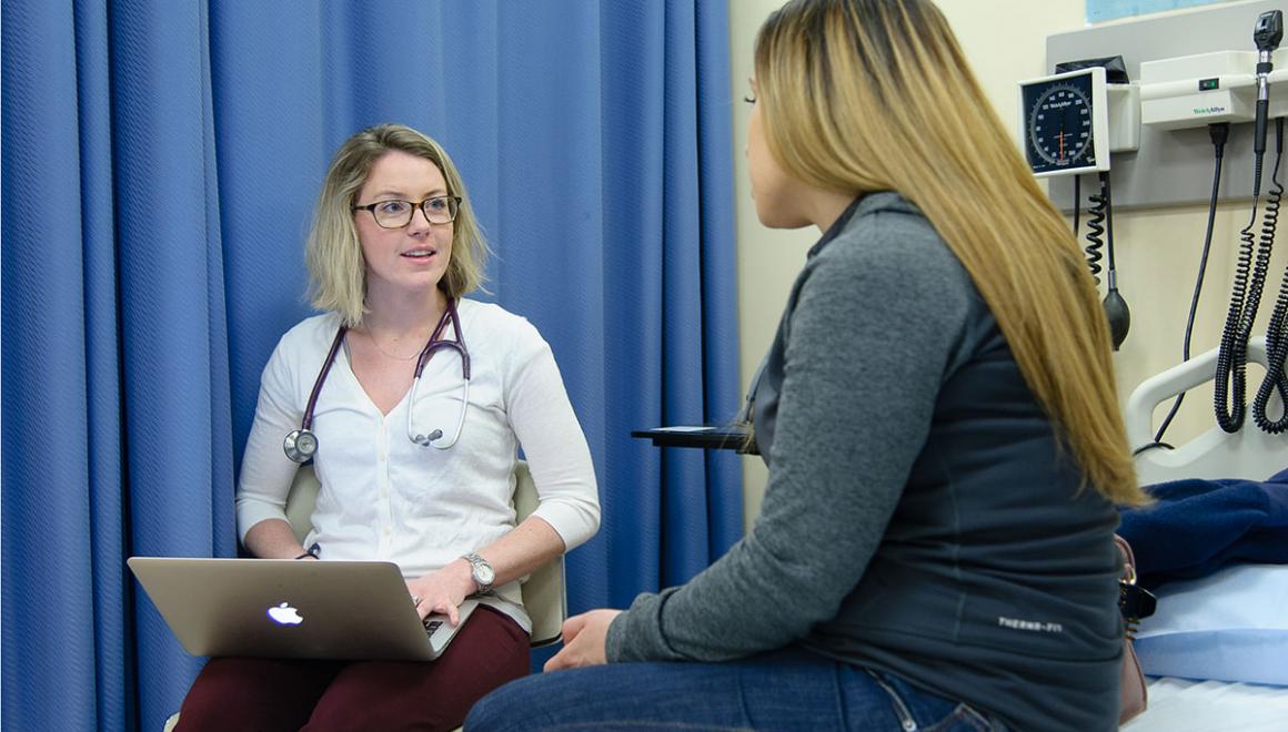 A Simmons nursing student conducting a patient interview