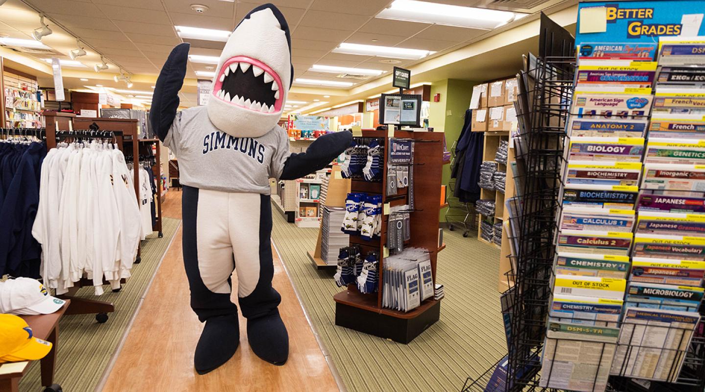 Stormy, the Simmons mascot, wearing a Simmons shirt in the Bookstore
