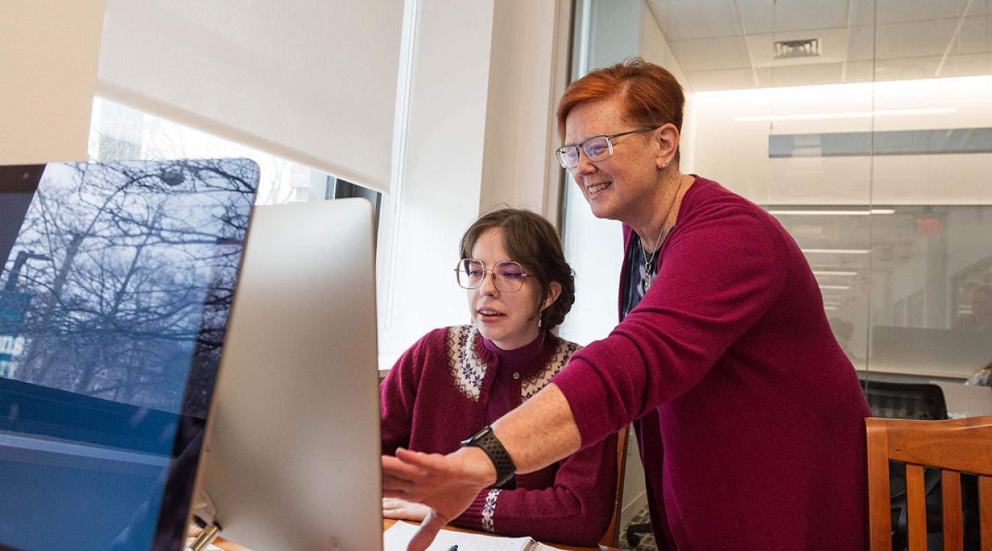 A Library and Information Science faculty member working with a student