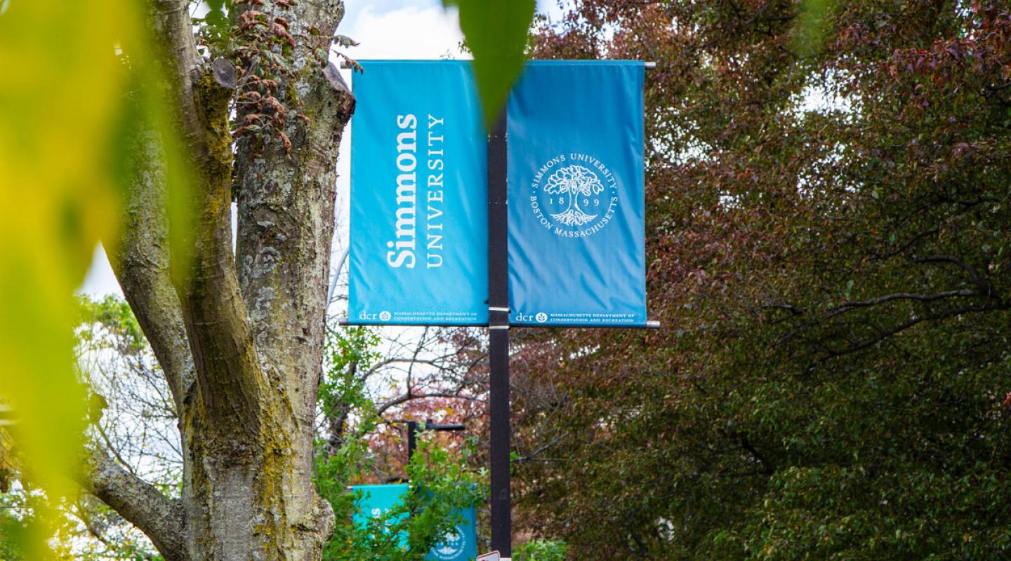 A lightpost with a Simmons University banner attached.