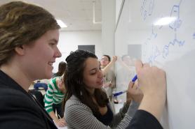 Students working on a white board