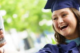 Student at Commencement taking a selfie