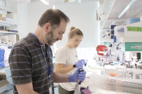 Eric Luth working with a student in a science lab