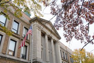 US flag in front of the Simmons University Main College Building