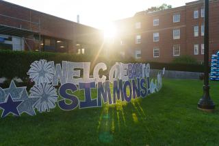A lawn sign on the Simmons University campus that reads "Welcome Back to Simmons"