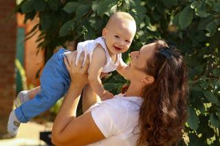 A mother holding her baby. Photo by Anna Keibalo on unsplash.com.