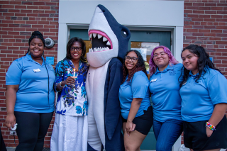 President Lynn Wooten with Stormy and Orientation Leaders at the candle lighting event during move-in weekend