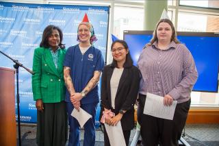 Kadyn Donovan ’27, Micah Joyce Guillermo ’26, and Abigail Gill ’26 with President Lynn Perry Wooten at the 2024 Founder's Day Celebration