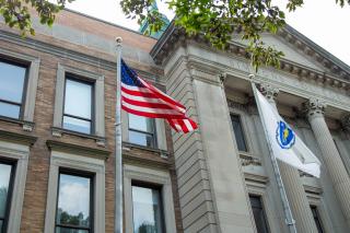 US Flag and MA State flag fying in front of Simmons MCB