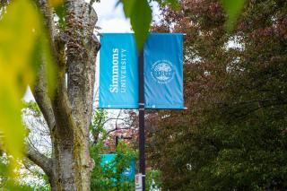 A lightpost with a Simmons University banner attached.