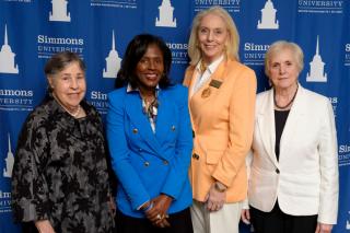 President Lynn Perry Wooten, Dean Astrid Sheil and two alums at the welcome event for the new SOM Dean.