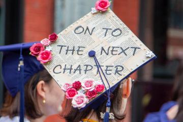 A Commencement cap with the message "On to the Next Chapter"