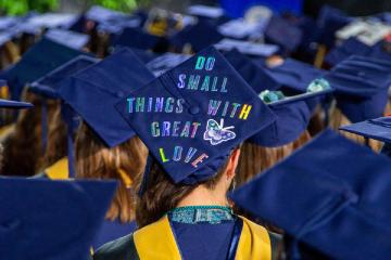 Commencement cap with the message "Do small things with great love"