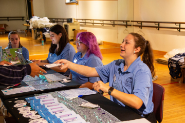 Orientation leaders handing out helpful information during move-in day 2024