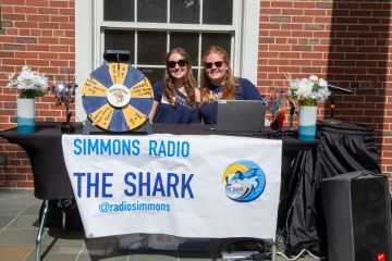 Students at a table for Simmons Radio, "The Shark" during Orientation weekend 2024