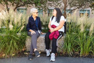 Faculty member Nanette Veilleux sitting with student