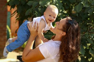 A mother holding her baby. Photo by Anna Keibalo on unsplash.com.