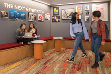 Simmons students working in and walking through the Ifill School lobby