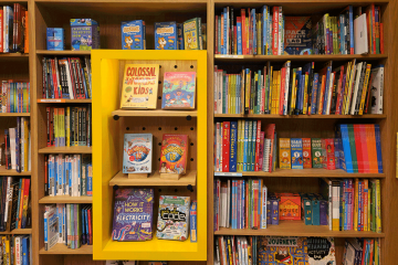 Shelves full of children's books. Photo by Zoshua Colah on Unsplash.  