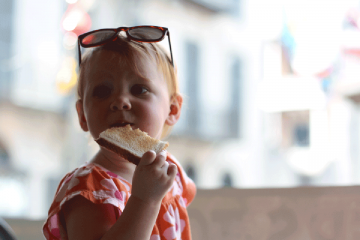 A small child eating a piece of toast.