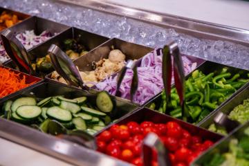 A selection of cut vegetables arranged in a salad bar