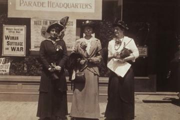 Three women standing in front of the parade headquarters of the Massachusetts Woman Suffrage Association, 1914