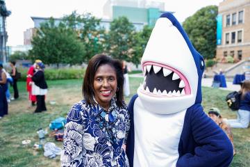 Simmons President Lynn Perry Wooten with Stormy the Shark, the Simmons University mascot