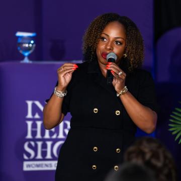 Dotson Mentor Sasha DuBois '08BSN speaking at the In Her Shoes Women's Conference in 2024.