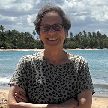 Wanda Torres Gregory standing on sunny beach