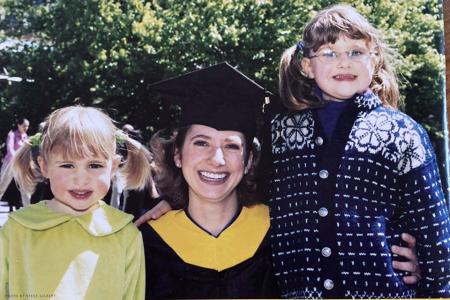 Abby (Bent) McKie with her younger sisters at her Commencement from Simmons