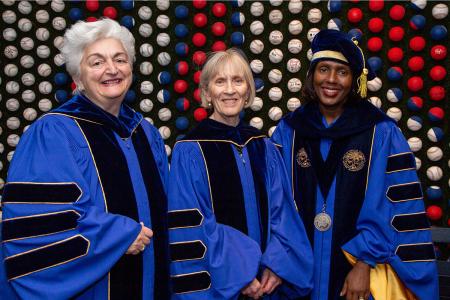 Board Chair Regina Pisa, Honorary Degree Recipient Claudia Goldin and President Lynn Wooten dress in Commencement robes 