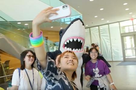 Students taking a selfie with Stormy, the Simmons mascot