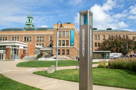 A blue emergency phone located on the Simmons campus