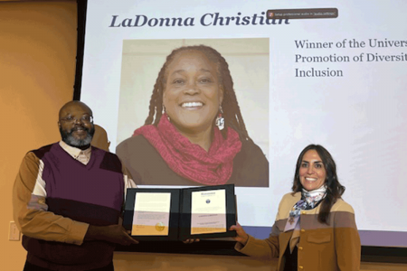 Teaching Professor of Nursing Chaluza Kapaale and Provost Stephanie Cosner stand with a projected photo of Associate Professor of Practice LaDonna Christian at the 2024 Faculty Awards