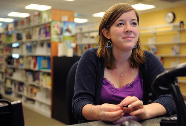 A librarian sitting at her desk