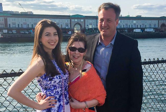 A simmons student standing with her parents