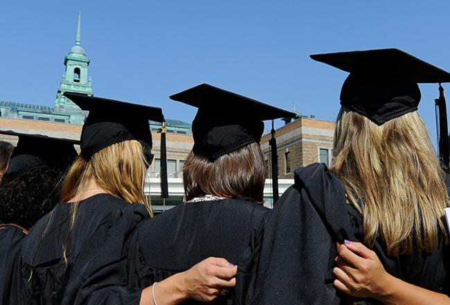 Photo of Graduates posing together in front of the Simmons MCB