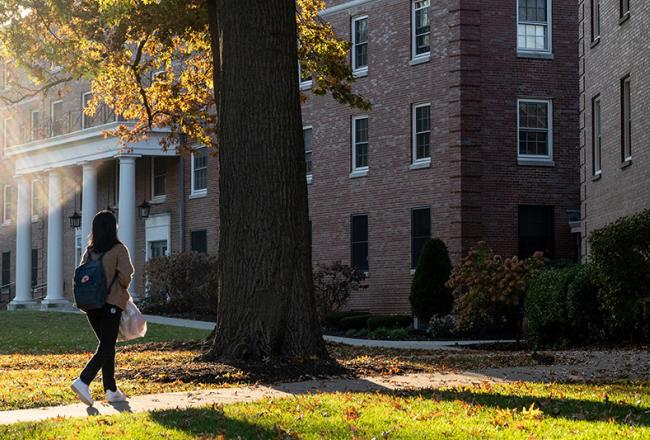 Student walking through residence campus