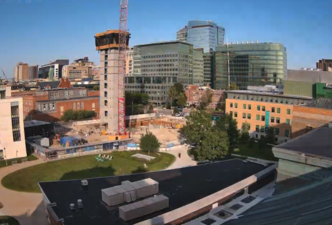 Photo of the LLC Construction site, including the beginning of the elevator crane