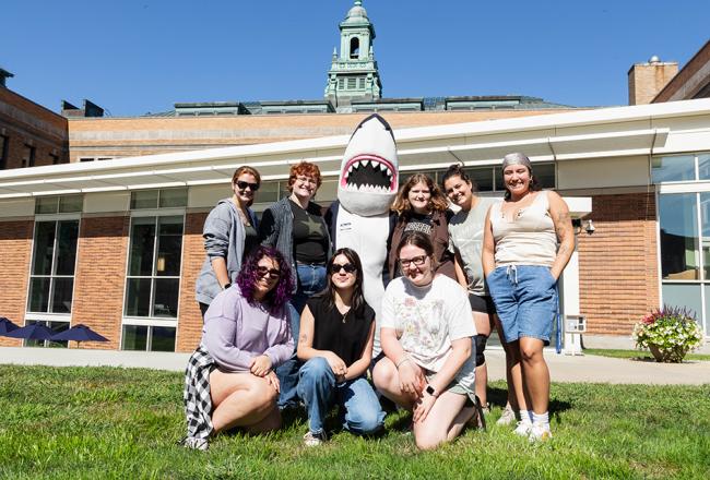 Students posing with Stormy Shark on campus