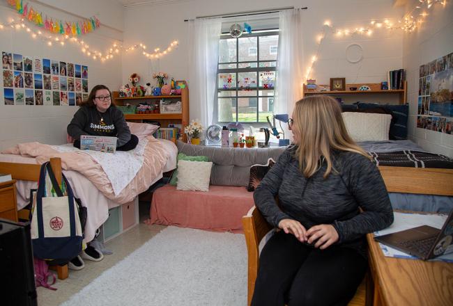 Two Simmons students talking in their residence hall room